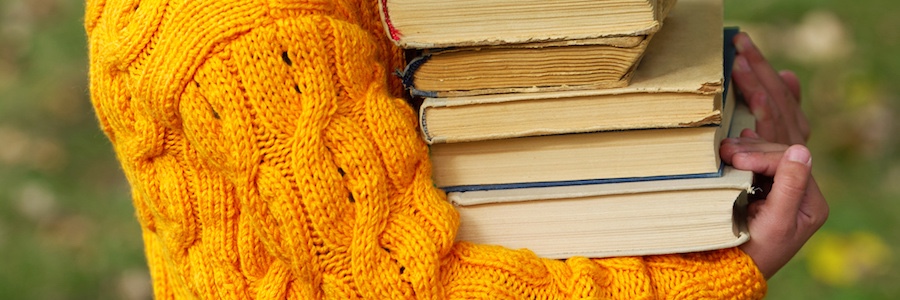 Image of person carrying books