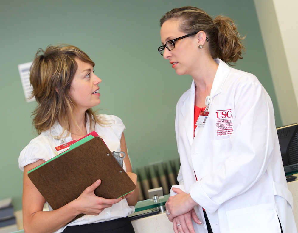 Dr. Katie Jordan (right), Associate Chair of Occupational Therapy Clinical Services, confers with Dr. Camille Dieterle (left), Director of the USC Occupational Therapy Faculty Practice | Photo by Phil Channing