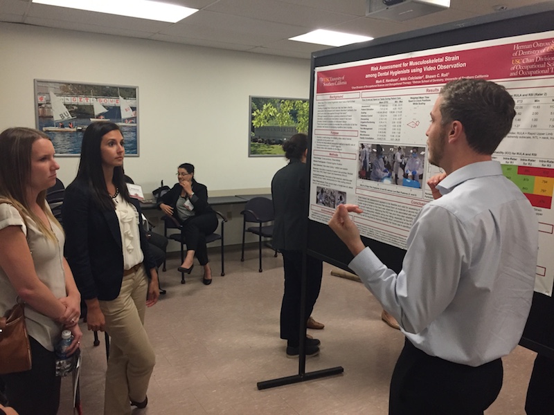 Mark discussing his research poster at the 2017 OT summit