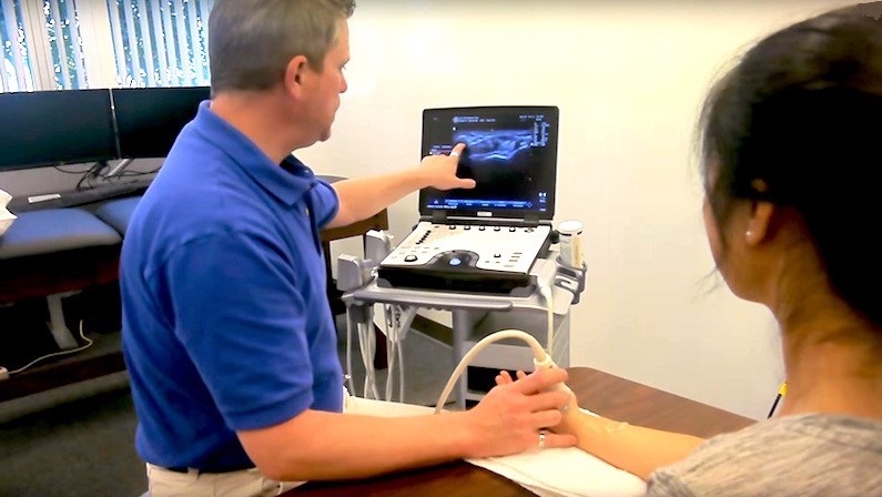 Dr. Roll evaluating the carpal tunnel with sonographic imaging