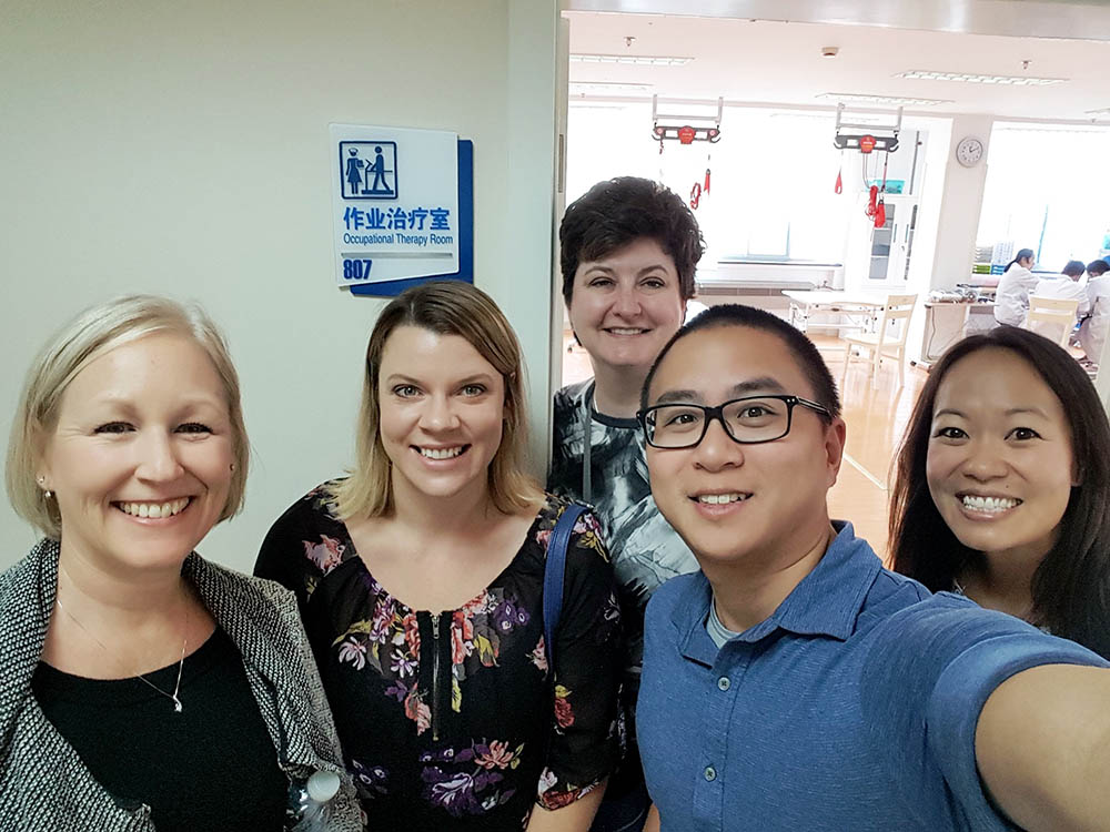 USC Chan Division China Initiative team takes a selfie in front of the OT Room at a hospital affiliated with Shanghai Jiao Tong University