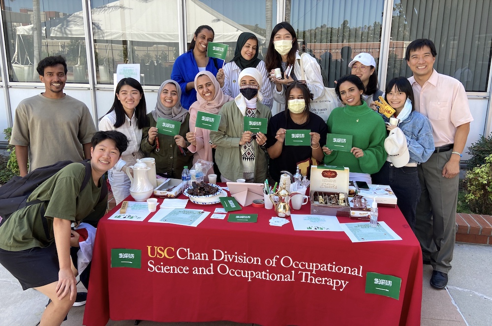 USC Chan students with coffee and the Saudi Arabian flag