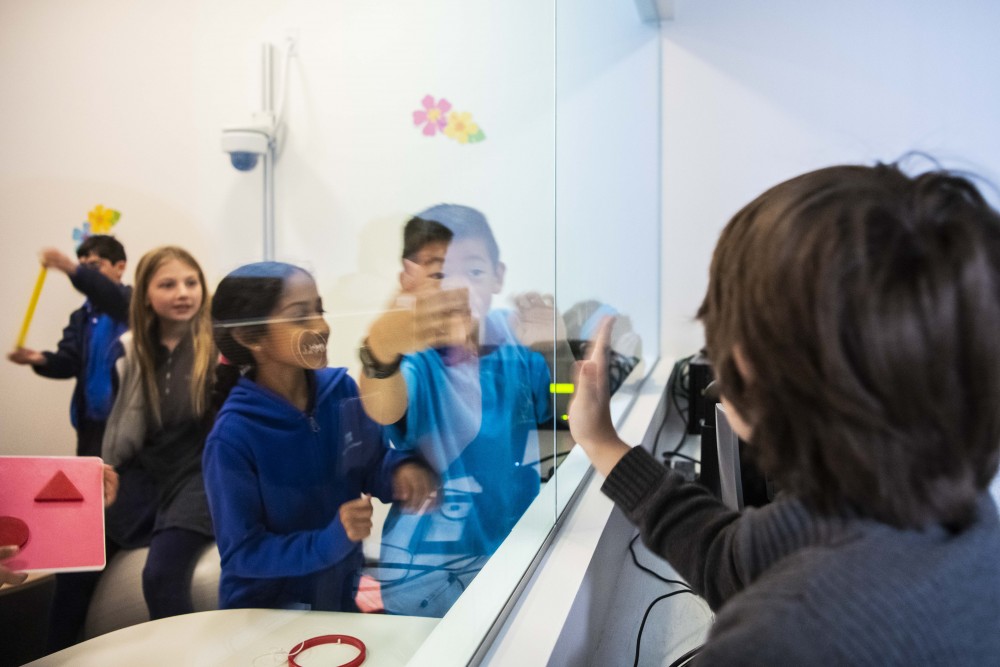 Students see how one-way mirrors will be used by the insp!re lab's research studies. (Photo by Hannah Benet)