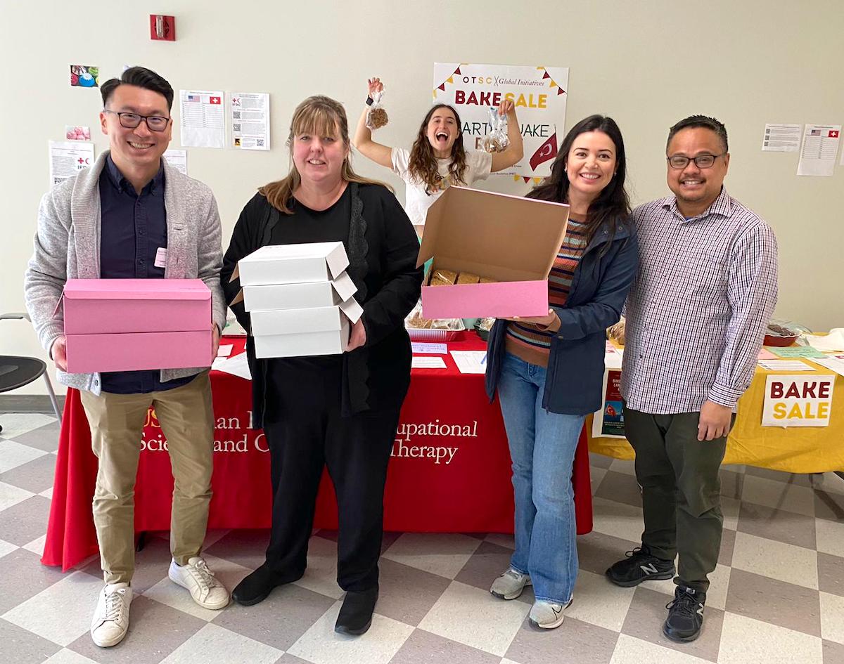 Assistant Professor James Lee, Chan staff member Ann Cassar, Michelle Rosas (MA ’23), and Student Services Advisor Ryan Pineda delivering baked goods from Davi Dinh.