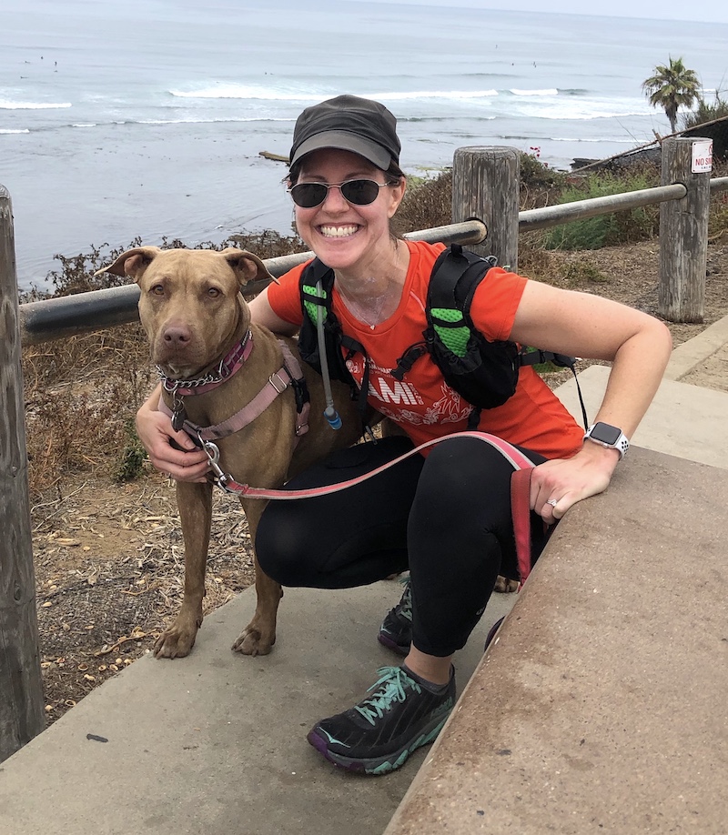Rachel Schey with her dog, Gracie, on a beachside hike
