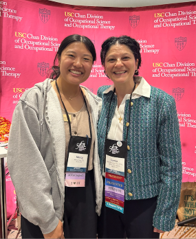 Mercy Deng sands with another woman, Dr. Samia Rafeedie, at the OTAC conference. They are both smiling.