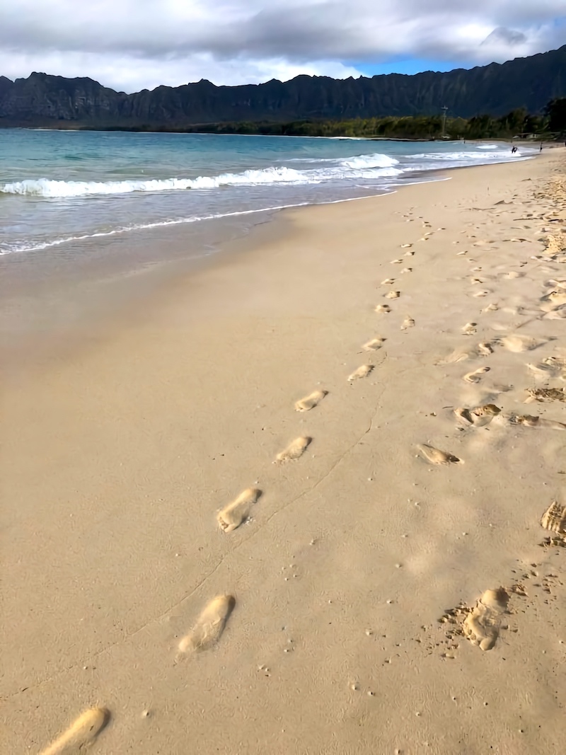 Beach walk with footprints in the sand