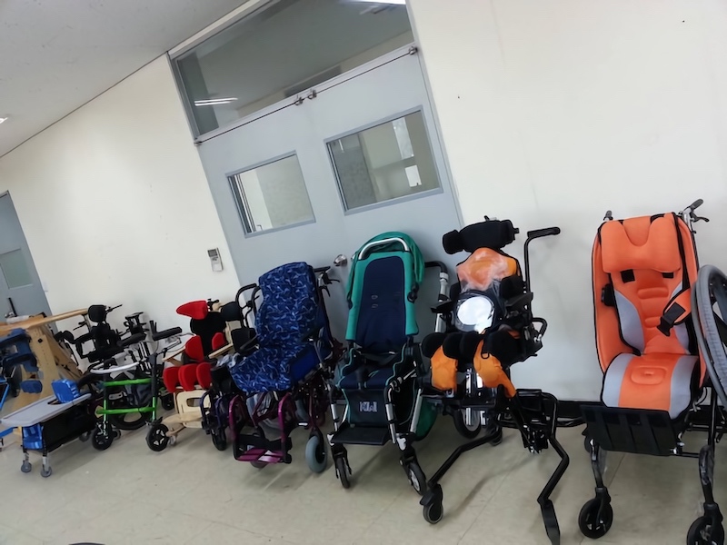 The wheelchairs include some designs by OT students!