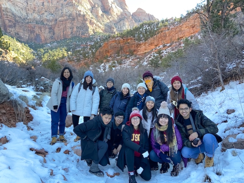 Another group photo with the mountain on the background but with more snow on the ground.
