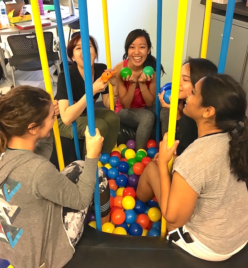Photo of students playing in a ball pit