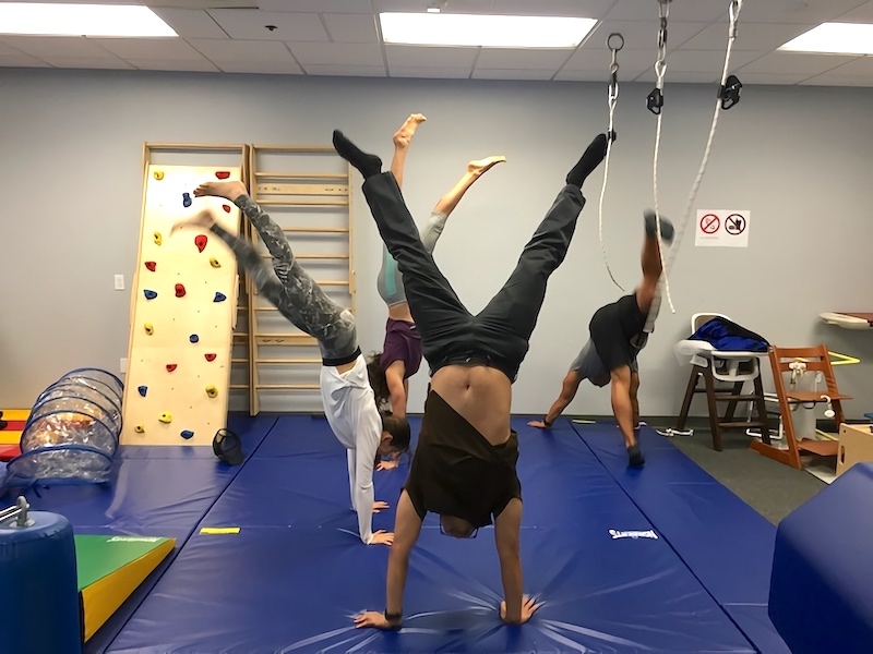 Writer doing handstands in PEDS lab