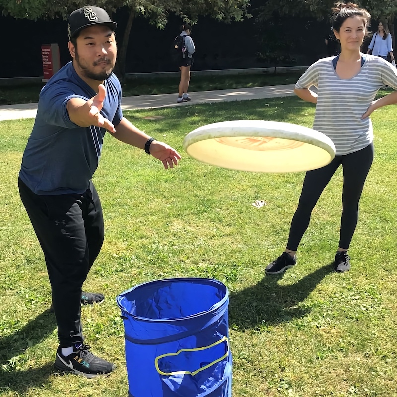 MA-II student Ty Kim throwing a frisbee to his partner while playing KanJam