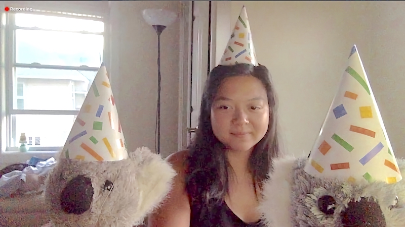 Screenshot of Alyssa and her two stuffed animal koalas on Zoom from last year during remote learning. They are each wearing a birthday party hat